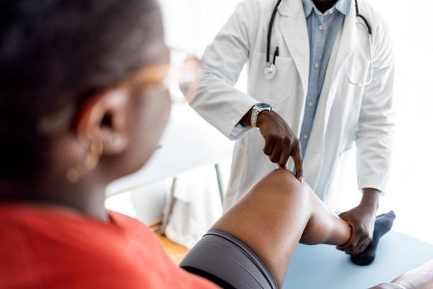Shot of young male physiotherapist doing a consultation and assessment with a female patient.