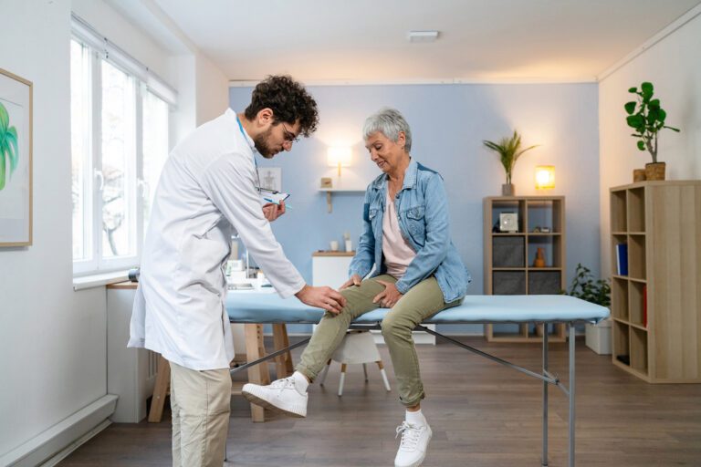 Senior female patient being examined for knee pain relief.